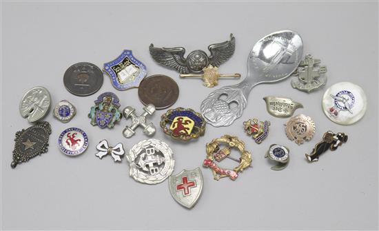 A yellow metal badge and other assorted badges